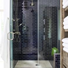 Walk-In Shower Features Black Subway Tile, Chrome Fixtures and a Built-In Bench