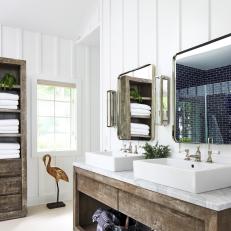 Bathroom With Vaulted Ceilings and Exposed Beams Features a Double Wood Vanity With Marble Countertops