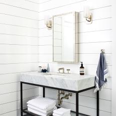 Bright Bathroom Features Shiplap Accent Walls and a Marble and Modern Vanity and a Chrome Mirror