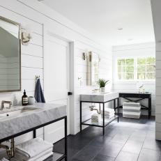Bright Bathroom Features a Shiplap Accent Wall, Matching Iron Vanities and Black Marble Tile Flooring 