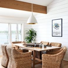 Bright Dining Room Features Vaulted Ceilings With Exposed Beams and a Shiplap Accent Walls