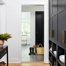 Modern Hallway Feature Built-In Cabinets, a Console Table and a Vintage Rug
