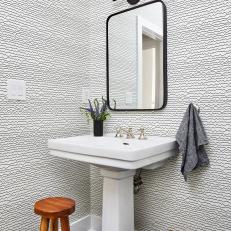 Modern Powder Room Features Black and White Wallpaper, a Pedestal Sink and a Modern Mirror 
