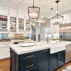 Open Concept Kitchen Features a Large Island and a Built-In Bar With a Glass Backsplash