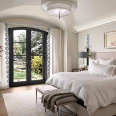 Neutral Transitional Bedroom With Black French Doors