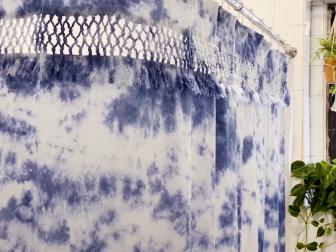 Tie-Dye Shower Curtain Hanging on Shower Rod In Tiled Bathroom