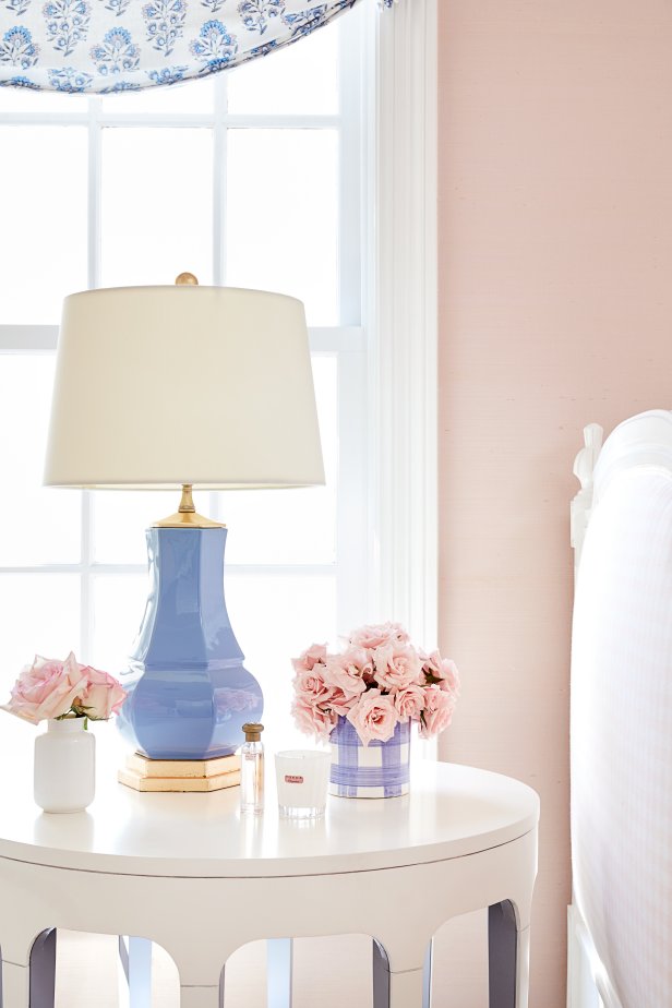 Nosegays of roses bring a touch of romance to this bedside table tableau.