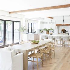 Open Concept Scandinavian Dining Area With Beams