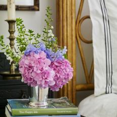 Flower Arrangement and Books on Traditional Nightstand