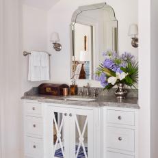 White Traditional Vanity with Sconces, Mirror and Floral Arrangement 