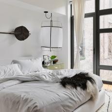 Eclectic Main Bedroom With Oversized Pendants