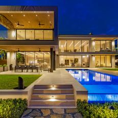 Modern Home Exterior With Brightly Lit Backyard