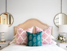 Why stop at matching lamps? Two brass-rimmed mirrors by Arteriors Home amp up the calming symmetry in this bedroom. Ones that dangle from chains are an unexpected twist.
