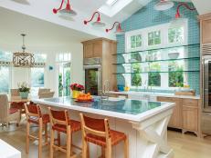 Open Plan Blue Kitchen With Red Sconces