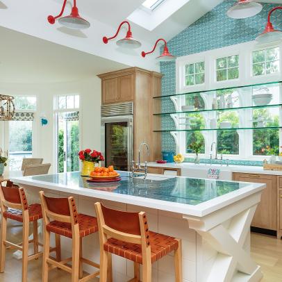 Open Plan Blue Kitchen With Red Sconces