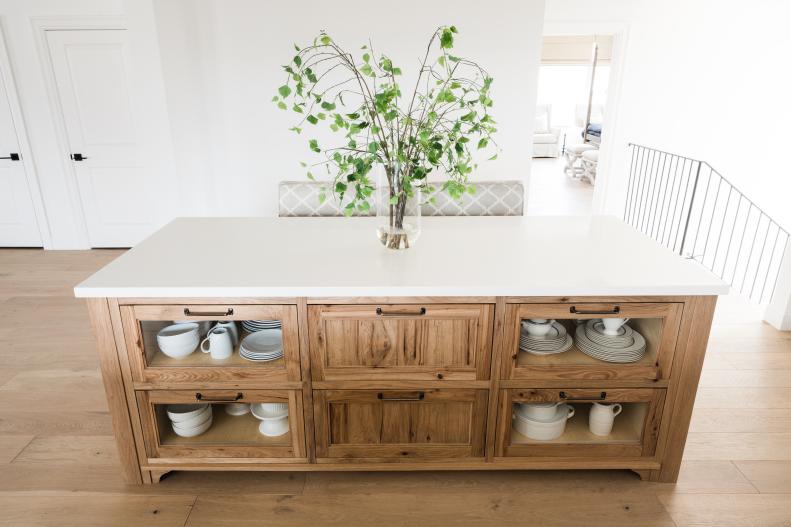 Wood Island Topped With White Stone Features Built-In Storage 