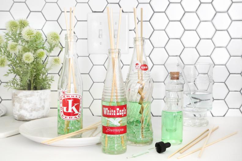 Vintage soda bottles have a nostalgic charm that works double duty as décor and room freshener! Create a scent diffuser with glass soda bottles and ordinary bamboo skewers. Fill a bottle with a simple 3:1 ratio of water to rubbing alcohol, mixed with a few drops of your favorite essential oil. Add decorative rocks, beads or glass marbles into the bottom of the bottle if desired.