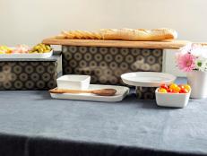 Create a buffet with appeal that goes beyond the meal. Using cardboard boxes and gift wrap, you can add dimension and height to your buffet, giving it an upscale, catered look.