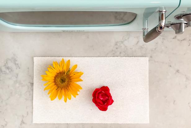 Place the blooms on a paper towel and lay another paper towel on top. Place them inside the microwave and add weight by adding a microwave-safe casserole dish on top. Make sure all the flowers are under the weight.