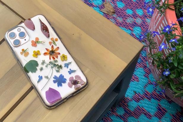 Cell Phone With Pressed Flowers on Outdoor Table