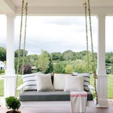 Porch Swing With Striped Pillows