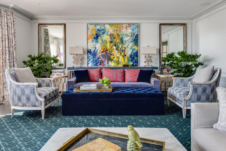 Velvet Ottoman on Green Rug in Living Room With Contemporary Art