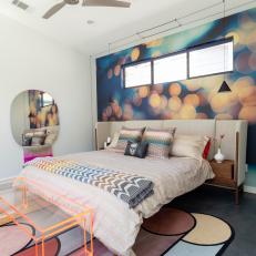 Modern Bedroom Features a Colorful Wallpaper Accent Wall and an Upholstered Headboard