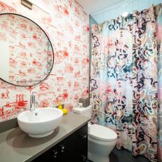 Colorful Bathroom Features Bold Wallpaper and a Patterned Shower Curtain