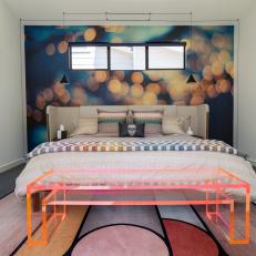 Modern Bedroom Features a Colorful Accent Wall and an Upholstered Headboard