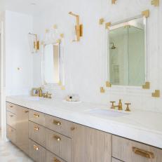 Modern Double Vanity Bathroom Features Lucite and Gold Mirrors and Gold Fixtures