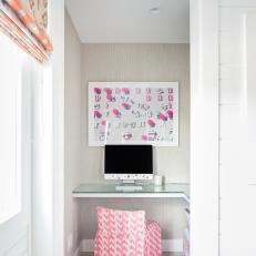 Small Home Office Nook Features a Built-In Glass-Topped Desk and a Beach-Themed Art Print