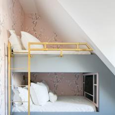 Kids' Bedroom Features Built-In Bunk Beds With Gold Railings and a Pink Wallpaper Accent Wall
