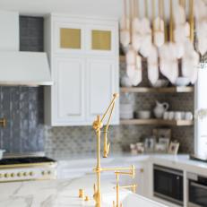 Eclectic Kitchen Features Luxe Marble Countertops, an Undermount Sink and an Antique Gold Faucet and Fixtures
