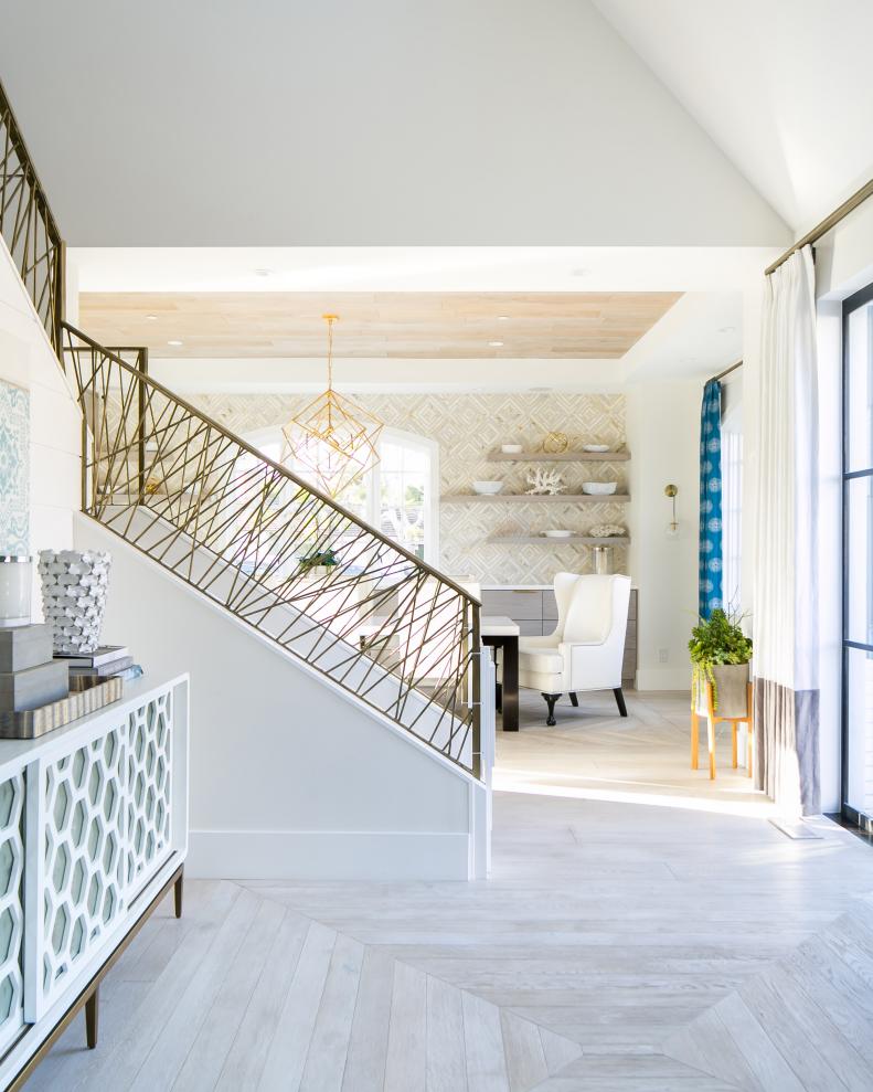 Bright Entry Features a Modern Console Table and Set of Stairs 