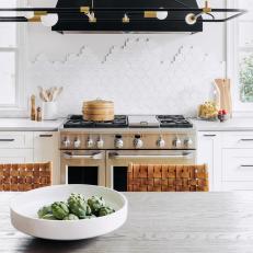Bright, Open Plan Kitchen Features a Mosaic Tile Backsplash and White Cabinets