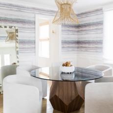 Eclectic Dining Room Features Multicolor Wallpaper and a Marble-Topped, Round Dining Table