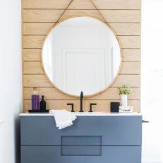 Bright Bathroom Features a Wood Accent Wall and a Single Floating Vanity 