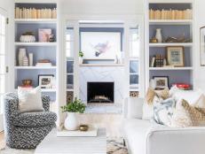 Neutral Living Room Features Built-In Bookshelves and Pocket Doors