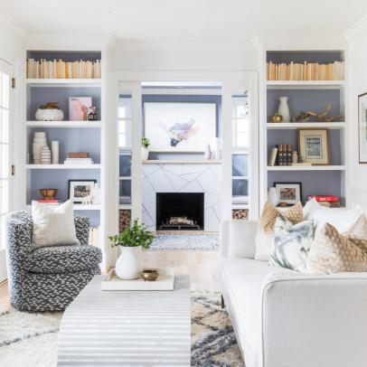 Neutral Living Area Features Built-In Bookshelves and Pocket Doors That Open to a Sitting Area