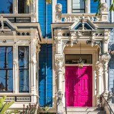 Blue Victorian-Style Home Features a Bright Pink Door and White Accents