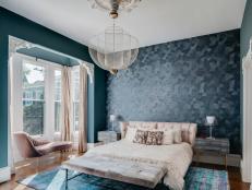 Blue Bedroom Features Modern Wallpaper and a Chandelier
