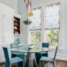 Modern Dining Nook Features Colorful Pendants and Unique Dining Furniture 