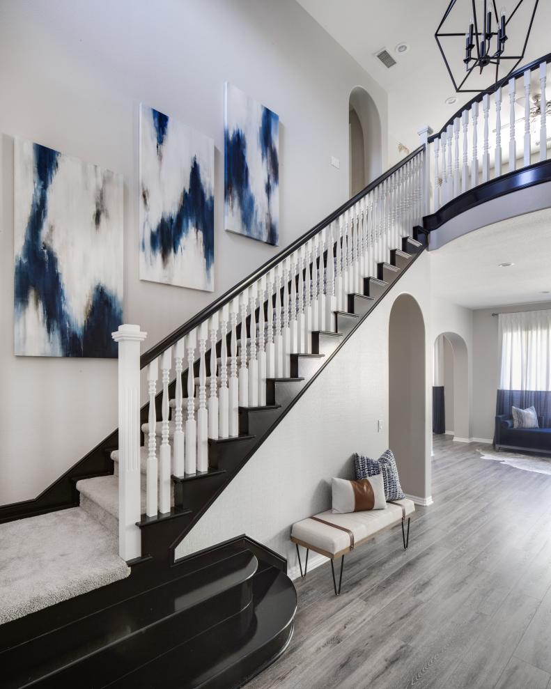 Classic Black Accents and Stairwell Gallery Wall Make for Majestic Entry