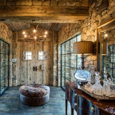 Rustic Stone Foyer With Round Ottoman