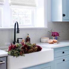 Classic Farmhouse Sink and Face-Frame Cabinetry in Gorgeous Blue-and-White Kitchen