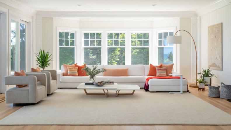Living Room With Bay Windows Features a Sectional and a Modern Accents