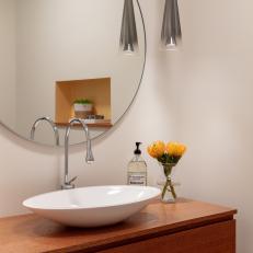 Powder Room Features a Floating Vanity With a Vessel Sink, a Round Mirror and an Eclectic Hanging Light Fixtures