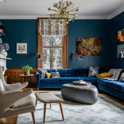 Moody Midcentury Modern Living Room Features a Velvet Sectional and Eclectic Decorative Accents