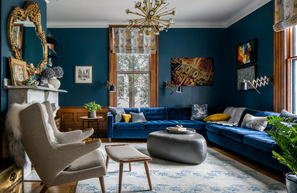 Moody Midcentury Modern Living Room Features a Velvet Sectional and Eclectic Decorative Accents