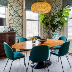 Eclectic Dining Room Features a Unique Light Fixture and a Midcentury Modern Table and Dining Chairs
